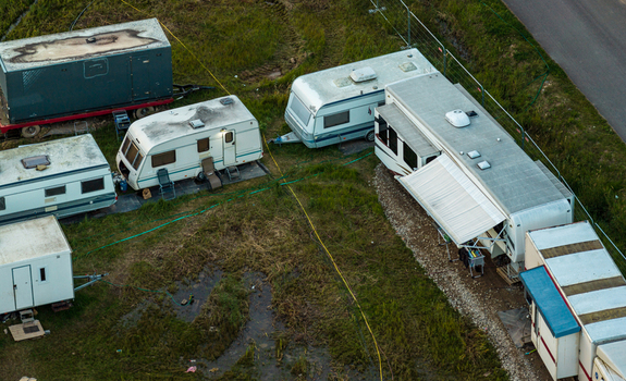 Aerial view of several caravans and trailers parked in a grassy field in Vilnius Vilnius County Lithuania. Aerial view of several caravans and trailers parked in a grassy field in Vilnius Vilnius County Lithuania.