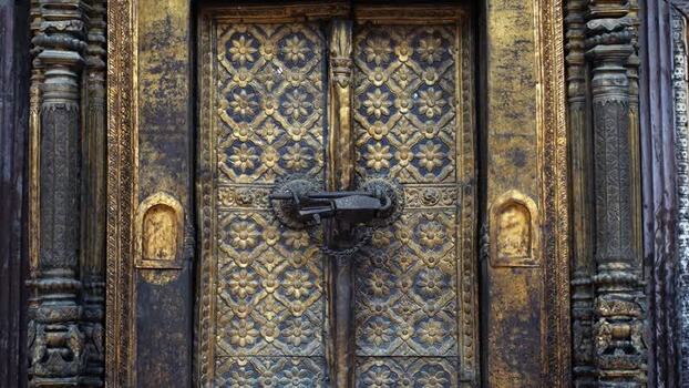 View of an ornate golden temple door with intricate carvings Nepal.