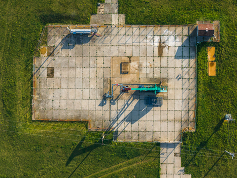 Aerial view of UGS Damborice gas storage facility with industrial machinery and concrete pads surrounded by green fields Damborice South Moravian Region Czechia. Aerial view of UGS Damborice gas storage facility with industrial machinery and concrete pads surrounded by green fields Damborice South Moravian Region Czechia.