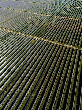 Aerial view of Limondale Solar Farm with rows of photovoltaic panels arranged in a geometric pattern across the landscape Balranald New South Wales Australia. Aerial view of Limondale Solar Farm with rows of photovoltaic panels arranged in a geometric pattern across the landscape Balranald New South Wales Australia.