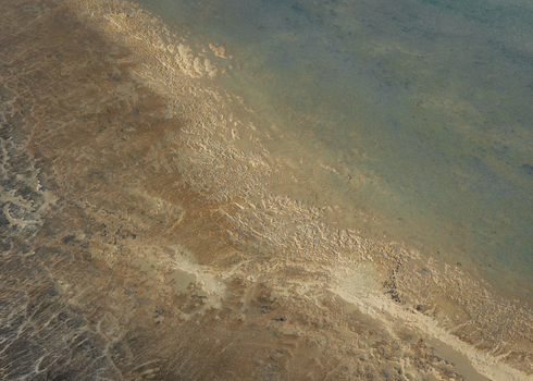 Aerial view of the shallow turquoise waters and intricate sand patterns along the coastline of Denham Western Australia Australia. Aerial view of the shallow turquoise waters and intricate sand patterns along the coastline of Denham Western Australia Australia.