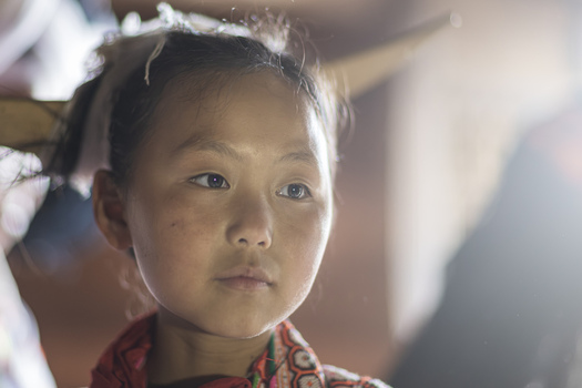Gaoxing China 29 April 2026 View of a young Long Horn Miao girl wearing traditional ethnic clothing and a large wooden horn headpiece in a soft lit indoor setting. Gaoxing China 29 April 2026 View of a young Long Horn Miao girl wearing traditional ethnic clothing and a large wooden horn headpiece in a soft lit indoor setting.