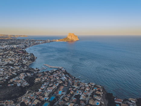 Aerial view of Penyal d Ifac rising above the Mediterranean Sea with the coastal town of Calp Valencian Community Spain. Aerial view of Penyal d Ifac rising above the Mediterranean Sea with the coastal town of Calp Valencian Community Spain.