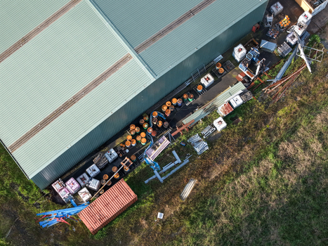 Aerial view of industrial factory site with storage containers metal barrels and construction materials stored outdoors in Kilsyth South VIC Australia. Aerial view of industrial factory site with storage containers metal barrels and construction materials stored outdoors in Kilsyth South VIC Australia.