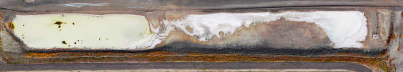 Aerial view of wastewater evaporation ponds by the Great Salt Lake featuring vibrant mineral colors crystallized salt deposits and crusted earth textures in Ogden Utah United States. Aerial view of wastewater evaporation ponds by the Great Salt Lake featuring vibrant mineral colors crystallized salt deposits and crusted earth textures in Ogden Utah United States.