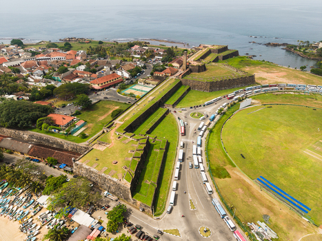 Aerial view of Galle Fort with its historic stone walls the clock tower and the adjacent cricket stadium Galle Southern Province Sri Lanka. Aerial view of Galle Fort with its historic stone walls the clock tower and the adjacent cricket stadium Galle Southern Province Sri Lanka.