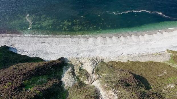 Aerial view of Glenlough Bay cliffs and beach Ireland.