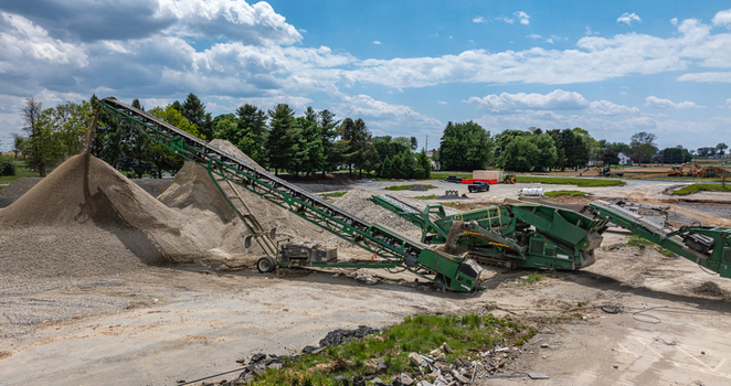 Aerial view of a green conveyor belt system processing gravel and sand into a large pile at a construction site in Ronks Pennsylvania United States. Aerial view of a green conveyor belt system processing gravel and sand into a large pile at a construction site in Ronks Pennsylvania United States.