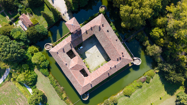 Aerial view of the historic Castello di Peschiera Borromeo a moated castle with a square courtyard and terracotta roof tiles in Peschiera Borromeo Lombardia Italy.