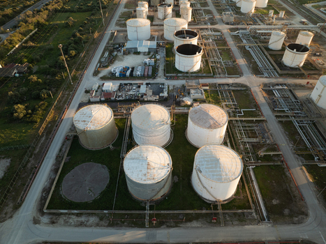 Aerial view of industrial storage tanks and complex piping systems at a refinery facility in Augusta Sicily Italy. Aerial view of industrial storage tanks and complex piping systems at a refinery facility in Augusta Sicily Italy.
