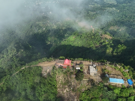 Aerial view of the Chandranath Temple atop the lush green hills of Sitakund surrounded by dense forest mist and winding paths in Sitakund Chittagong Division Bangladesh. Aerial view of the Chandranath Temple atop the lush green hills of Sitakund surrounded by dense forest mist and winding paths in Sitakund Chittagong Division Bangladesh.