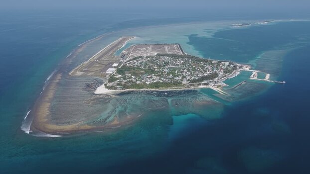 Aerial view of Kudahuvadhoo island and airport Maldives. Aerial view of Kudahuvadhoo island and airport Maldives.