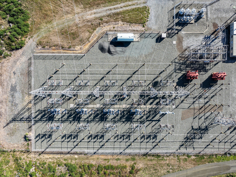 Aerial view of an electrical substation with transformers metal power structures and gravel ground in Bandon Oregon United States. Aerial view of an electrical substation with transformers metal power structures and gravel ground in Bandon Oregon United States.