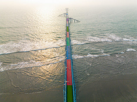 Aerial view of a colourful bridge stretches over the ocean its vibrant hues contrasting with the shimmering water Cox s Bazar Chittagong Division Bangladesh.