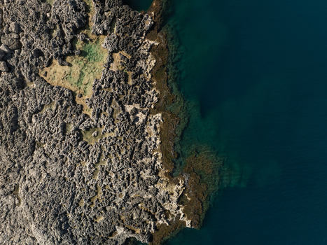 Aerial view of the jagged limestone coastline and crystal clear turquoise waters of Plemmirio Sicily Italy. Aerial view of the jagged limestone coastline and crystal clear turquoise waters of Plemmirio Sicily Italy.