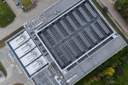 Aerial view of a modern AI data center with extensive cooling systems and industrial infrastructure on the rooftop in Warsaw Masovian Voivodeship Poland. Aerial view of a modern AI data center with extensive cooling systems and industrial infrastructure on the rooftop in Warsaw Masovian Voivodeship Poland.