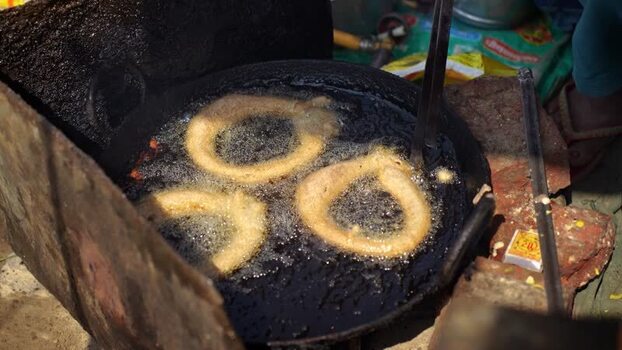View of traditional sel roti frying in hot oil Nepal.