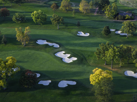Aerial view of a golf course in autumn with vibrant fall foliage manicured green fairways and white sand bunkers in Glenview Illinois United States. Aerial view of a golf course in autumn with vibrant fall foliage manicured green fairways and white sand bunkers in Glenview Illinois United States.