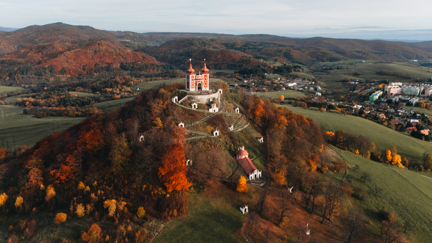 Aerial view of the Kalvaria Banska Stiavnica baroque complex on a hill surrounded by vibrant autumn foliage and rolling hills Banska Stiavnica Banskobystricky kraj Slovakia.