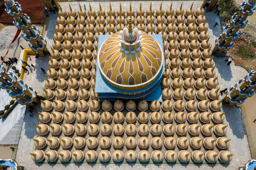Aerial view of the vibrant golden dome of the 201 Dome Mosque rises majestically above the surrounding structures Tangail Bangladesh. Aerial view of the vibrant golden dome of the 201 Dome Mosque rises majestically above the surrounding structures Tangail Bangladesh.