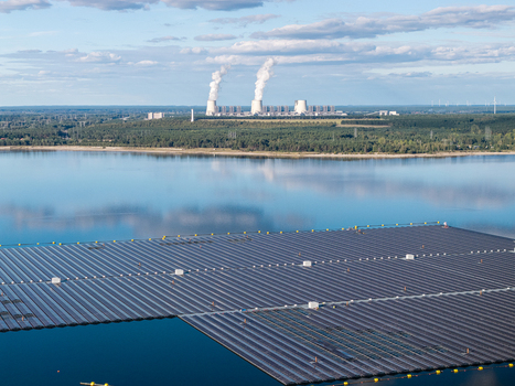 Aerial view of the floating solar park on Cottbuser Ostsee with the Janschwalde Power Plant in the background showcasing the energy transition in Cottbus Brandenburg Germany. Aerial view of the floating solar park on Cottbuser Ostsee with the Janschwalde Power Plant in the background showcasing the energy transition in Cottbus Brandenburg Germany.