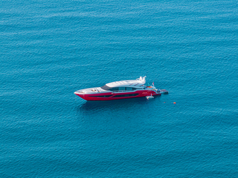 Aerial view of a luxury pleasure boat anchored in the clear blue waters of Lacona Bay Elba Lacona Tuscany Italy.