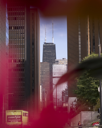 Chicago United States 15 September 2025 View of the John Hancock Center framed by modern skyscrapers and urban architecture under a clear blue sky.