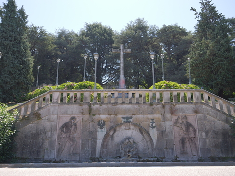 View of the historic stone monument with a central cross relief carvings and fountain at O Castro park in Vigo Pontevedra Spain.