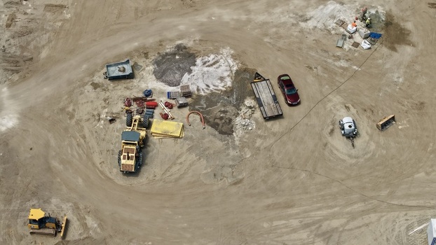 Aerial view of Foundry Lane construction site with heavy machinery a grader a bulldozer and workers on the dusty ground in World Golf Village Florida United States.
