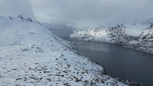 Aerial view of Kvaloya fjord and snowy mountains Norway.