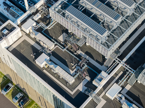 Aerial view of the Vantage Data Centers BER1 facility roof featuring complex HVAC systems ventilation units and industrial piping in Ludwigsfelde Brandenburg Germany. Aerial view of the Vantage Data Centers BER1 facility roof featuring complex HVAC systems ventilation units and industrial piping in Ludwigsfelde Brandenburg Germany.