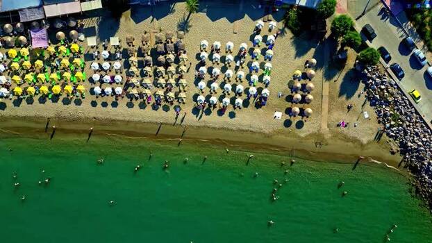 Aerial view of Crete beach with umbrellas and turquoise water Greece.