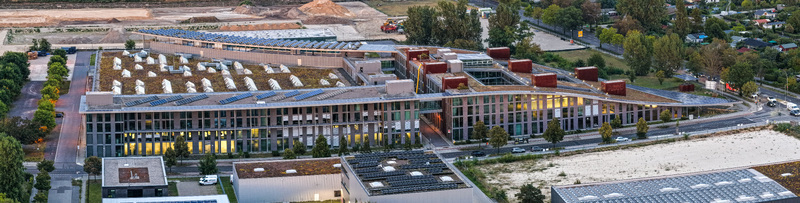 Aerial view of the Curve Campus tech and business hub in the Adlershof technology park featuring modern architecture with green roofs and solar panels in Berlin Berlin Germany. Aerial view of the Curve Campus tech and business hub in the Adlershof technology park featuring modern architecture with green roofs and solar panels in Berlin Berlin Germany.