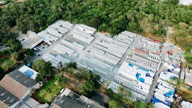 Aerial view of stacked fiber cement sheets in a storage yard India.