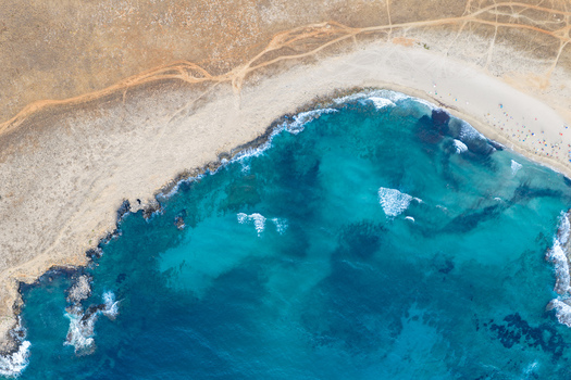 Aerial view of the turquoise waters and rocky coastline of Riserva Naturale Orientata dello Zingaro with sandy beach and trails in San Vito Lo Capo Sicilia Italy. Aerial view of the turquoise waters and rocky coastline of Riserva Naturale Orientata dello Zingaro with sandy beach and trails in San Vito Lo Capo Sicilia Italy.