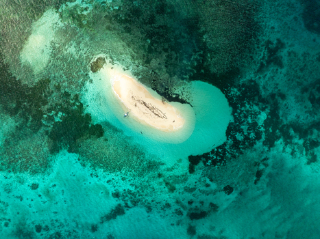 Aerial view of Naked Island surrounded by turquoise water and coral reefs in Siargao Philippines. Aerial view of Naked Island surrounded by turquoise water and coral reefs in Siargao Philippines.