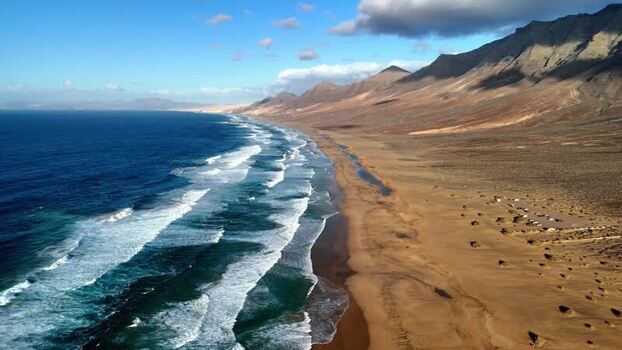 Aerial view of Playa de Cofete and rugged mountains Spain.