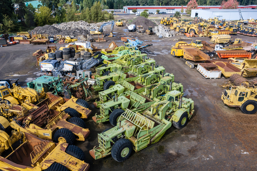 Woodburn United States 25 September 2026 Aerial view of a large storage yard filled with rows of heavy construction machinery including yellow and light green scrapers and bulldozers. Woodburn United States 25 September 2026 Aerial view of a large storage yard filled with rows of heavy construction machinery including yellow and light green scrapers and bulldozers.