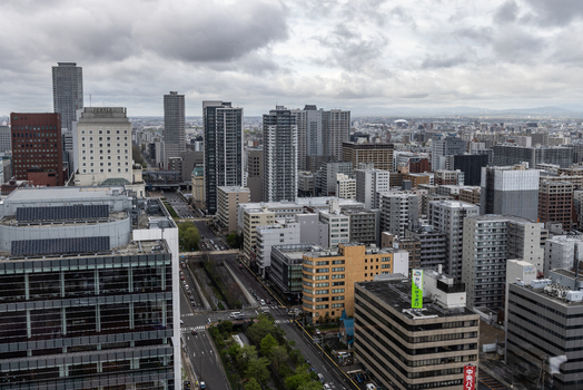 Aerial view of the dense urban skyline of Sapporo with modern high rise buildings office towers and busy streets in Sapporo Hokkaido Japan. Aerial view of the dense urban skyline of Sapporo with modern high rise buildings office towers and busy streets in Sapporo Hokkaido Japan.