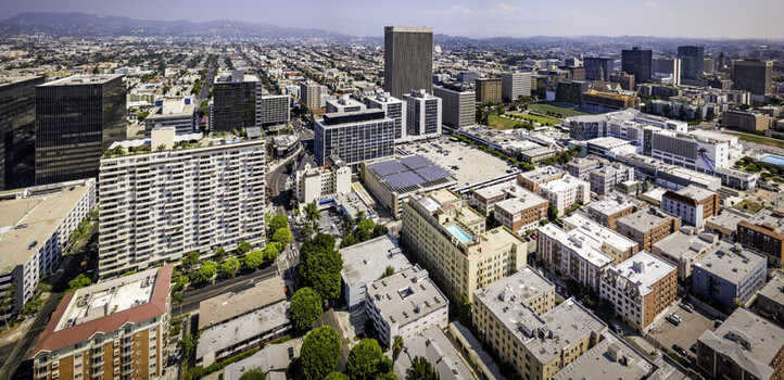 Los Angeles California United States 16 August 2018 Aerial view of solar panels on a building rooftop amidst the dense urban landscape. Los Angeles California United States 16 August 2018 Aerial view of solar panels on a building rooftop amidst the dense urban landscape.