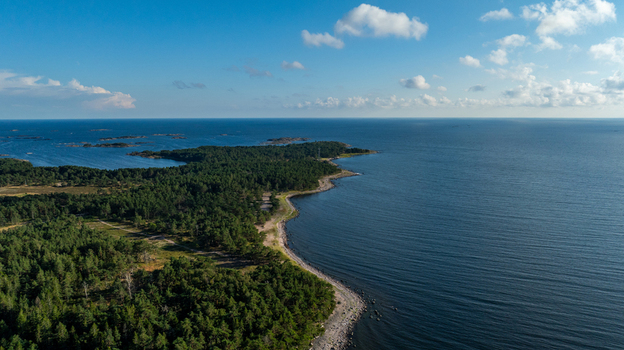 Aerial view of Oro Fortress Island featuring dense pine forests rocky shorelines and calm blue waters of the Baltic Sea in Oro Varsinais Suomi Finland. Aerial view of Oro Fortress Island featuring dense pine forests rocky shorelines and calm blue waters of the Baltic Sea in Oro Varsinais Suomi Finland.