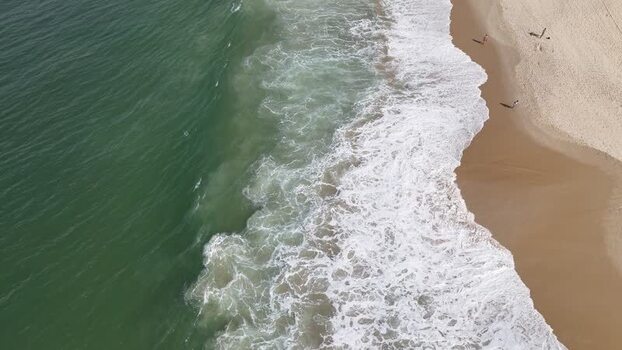 Aerial view of waves crashing on Copacabana Beach Brazil.