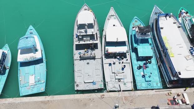 Aerial view of fishing boats docked at the pier in Maldives.