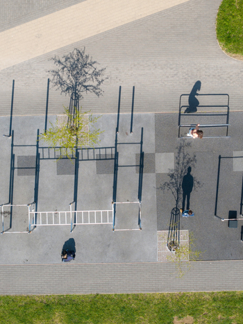 Vilnius Lithuania 20 April 2026 Aerial view of Chiune Sugihara Sakura Park with people exercising on calisthenics equipment and long shadows on the ground. Vilnius Lithuania 20 April 2026 Aerial view of Chiune Sugihara Sakura Park with people exercising on calisthenics equipment and long shadows on the ground.