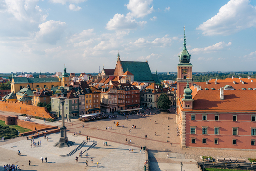 View of Warsaw Old Town featuring the Royal Castle Sigismund s Column and historic colorful buildings under a blue sky in Warsaw Masovian Voivodeship Poland. View of Warsaw Old Town featuring the Royal Castle Sigismund s Column and historic colorful buildings under a blue sky in Warsaw Masovian Voivodeship Poland.