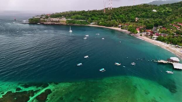Aerial view of coastal bay with boats in Bali Indonesia.