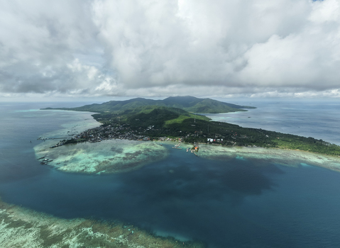 Aerial view of the island s contrasting deep blues of the ocean and the bright turquoise shallows meet the lush green landscape Karimunjawa Central Java Indonesia. Aerial view of the island s contrasting deep blues of the ocean and the bright turquoise shallows meet the lush green landscape Karimunjawa Central Java Indonesia.