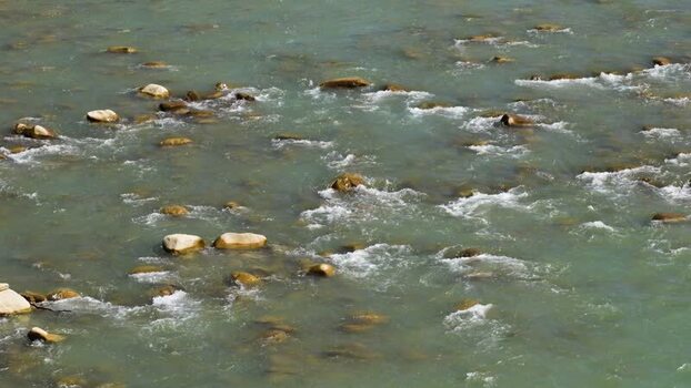View of a river flowing over smooth rocks Nepal.