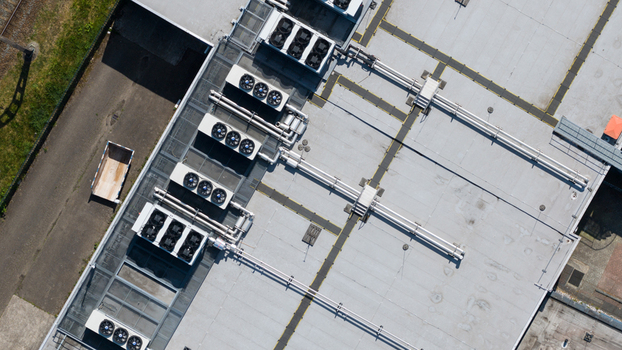 Aerial view of industrial rooftop with multiple HVAC cooling units and ventilation pipes in Nieuwegein Utrecht Netherlands. Aerial view of industrial rooftop with multiple HVAC cooling units and ventilation pipes in Nieuwegein Utrecht Netherlands.
