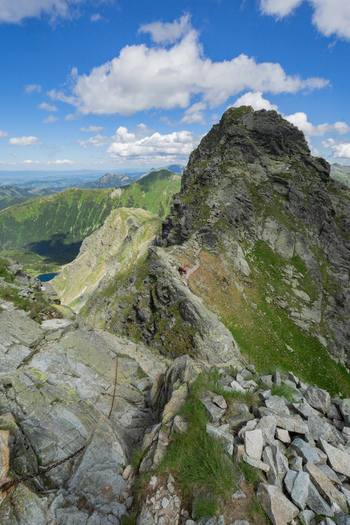 View of Tri kopy in Western Tatras showing a rocky mountain ridge with a hiking trail and safety chains under a blue sky Ziar Zilina Region Slovakia. View of Tri kopy in Western Tatras showing a rocky mountain ridge with a hiking trail and safety chains under a blue sky Ziar Zilina Region Slovakia.